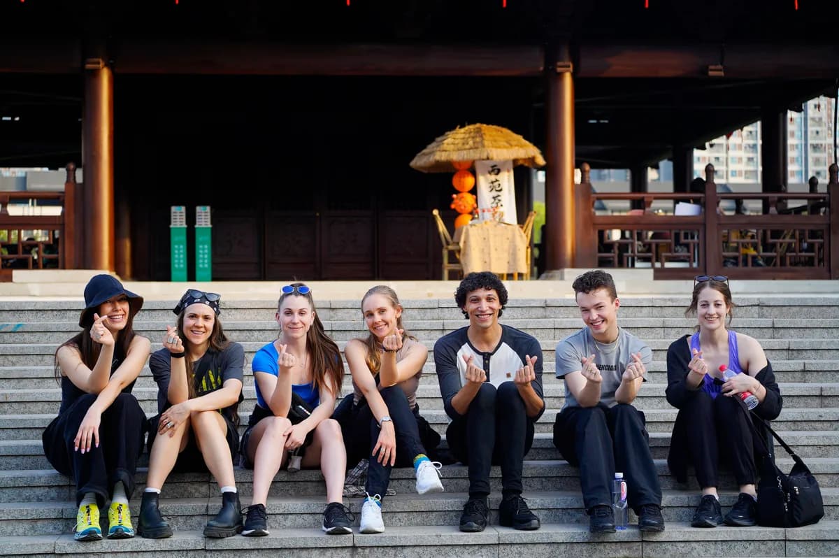 Troupe on temple steps, candid