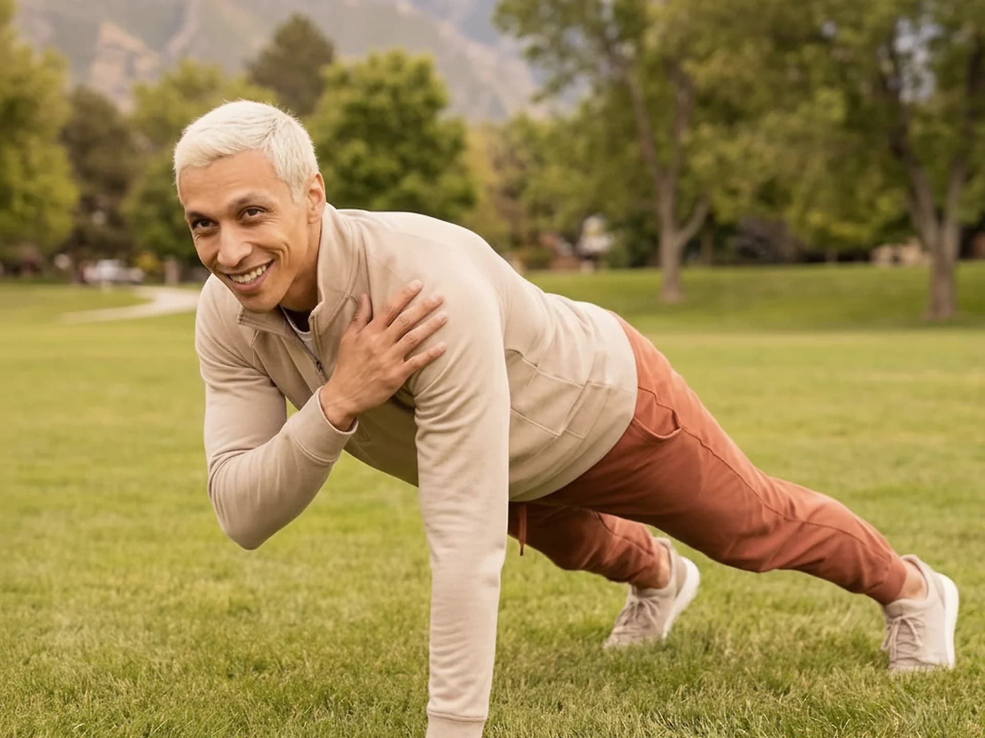 Vlad Pereira doing a one-arm plank outdoors in the mountains