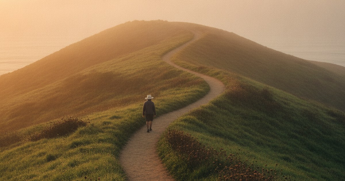 A coastal trail curving upward through green hills at sunrise on Vancouver Island