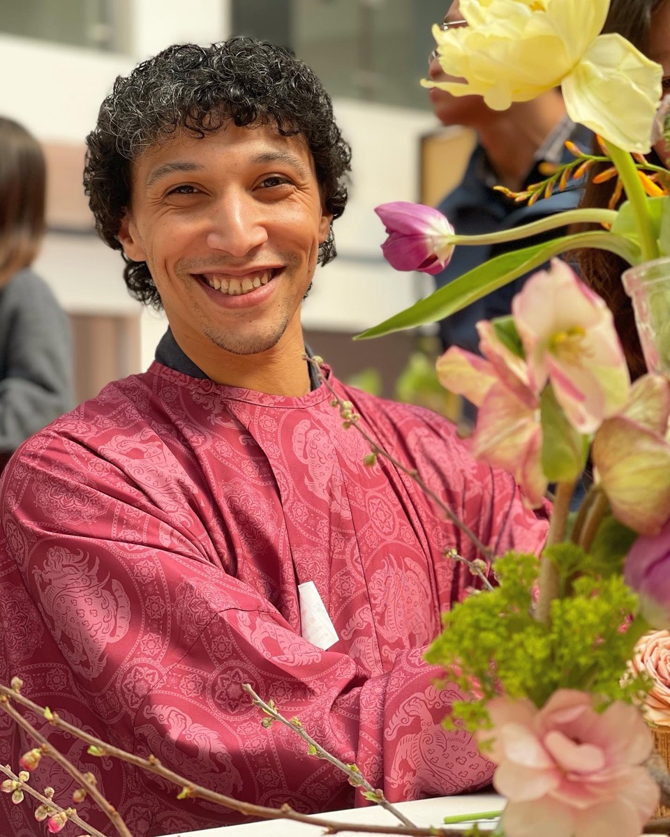 Vlad smiling with spring flowers