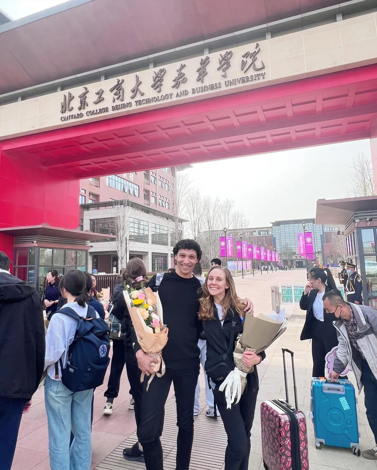 Vlad at Beijing Technology and Business University entrance with flowers