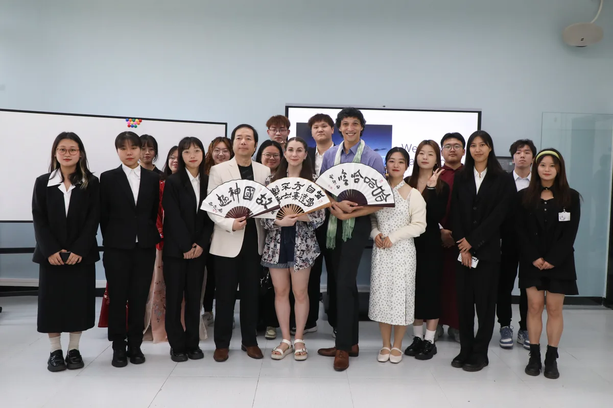 Group photo with traditional calligraphy fans