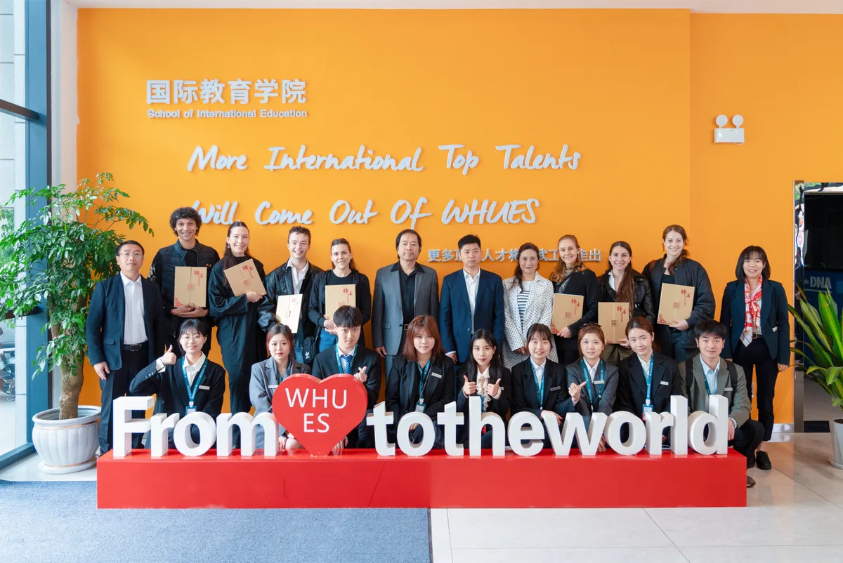Group photo with certificates at WHUES Wuhan